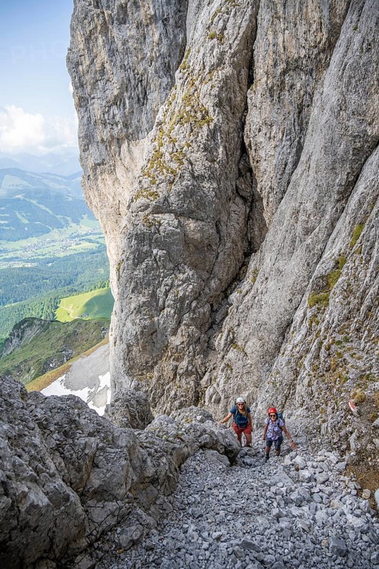 Two mountaineers with helmets climbing on a rock face, ascent to the Ackerlspitze, Wilder Kaiser, Kaiser Mountains, Tyrol, Austria