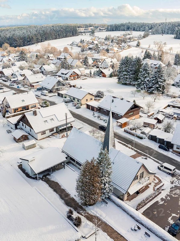 Snow-covered roofs and church in a wintry village, Oberreichenbach, Black Forest, Calw district, Germany