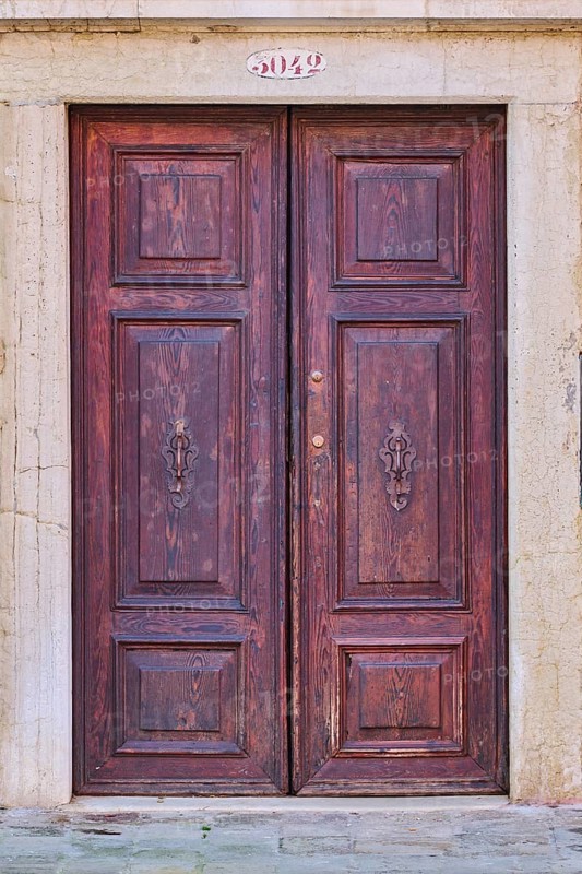 Door of an old house on 'Campo santa margherita' town square in Venice on a sunny day in winter, Italy