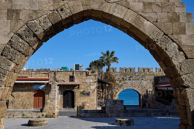 Arched wall overlooking the sea and historic buildings, Rhodes Old Town, Rhodes, Dodecanese, Greek Islands, Greece