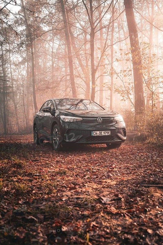 A Volkswagen in a peaceful atmosphere in a foggy, autumnal forest with incidence of light, electric car VW ID5, Deer Carsharing, Gechingen, Black Forest, Germany