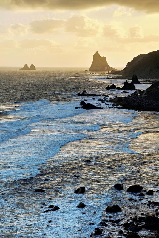 Beach of Playa de Benijo at high tide with the rock Roques de Anaga in the light of the rising sun, Tenerife, Canary Island, Spain