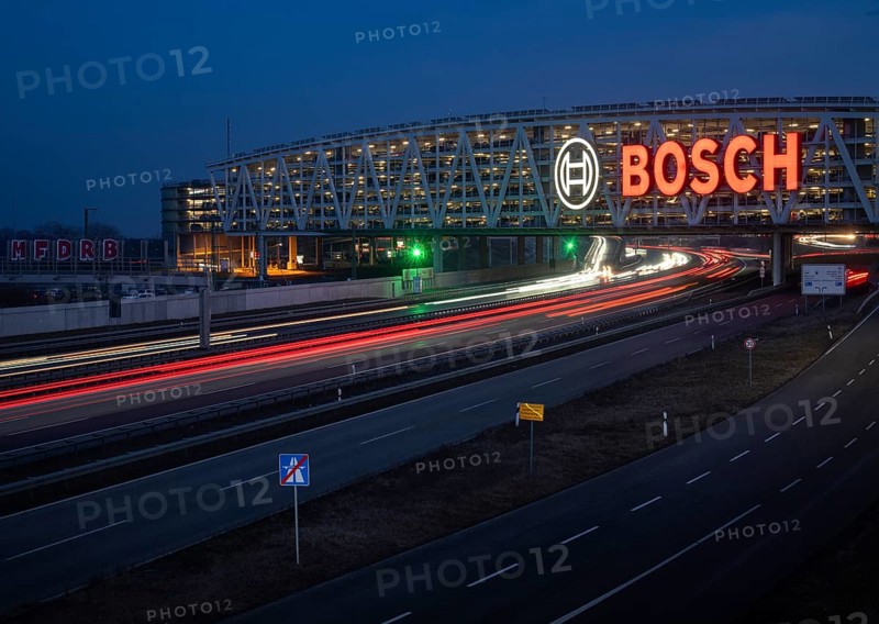 Traffic on the A8 motorway, blue hour, illuminated parking garage, Landesmesse Stuttgart, red-lit Bosch logo, second-largest logo in the world 55 meters wide, Baden-Württemberg, Germany