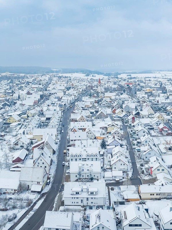 Small settlement under snow cover with straight main road, Deckenpfronn, Böblingen district, Germany