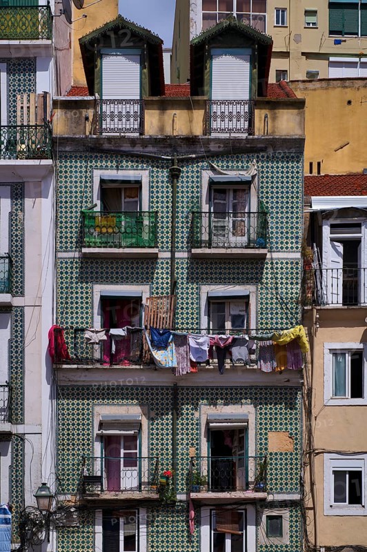 Residential building, house facade, narrow, azulejos, tiles, tile decoration, laundry for drying, balcony, old town, Lisbon, Portugal