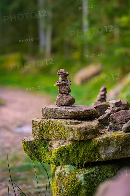 Balanced stone towers on a moss-covered stone along a forest path, Glaswaldsee, Bad Rippoldsau-Schapbach, Wolfach district, Black Forest, Germany