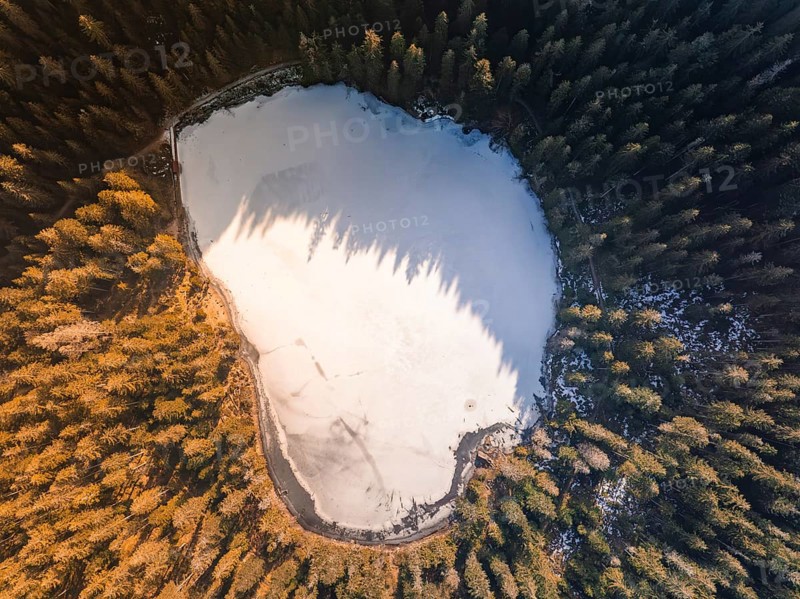 A frozen lake in the middle of a dense forest, photographed from the air, Glaswaldsee, Bad Rippoldsau-Schapbach, Black Forest, Germany