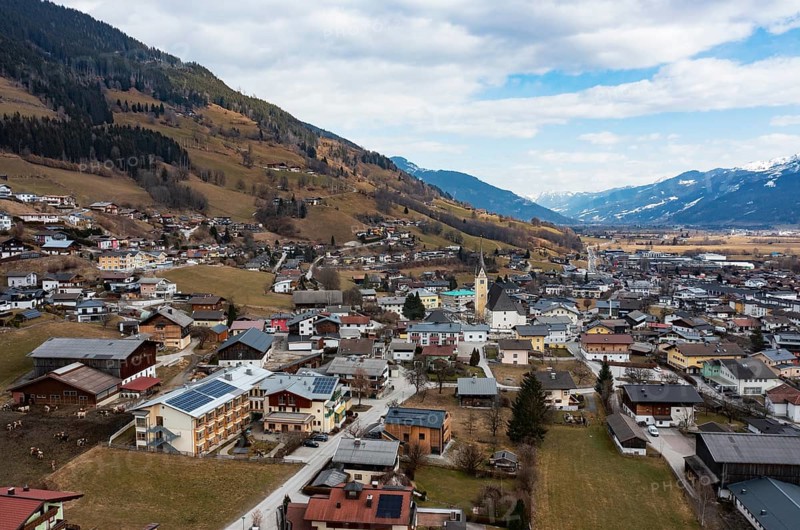 Drone shot, view of village with parish church, Piesendorf, Pinzgau, Salzburg province, Austria