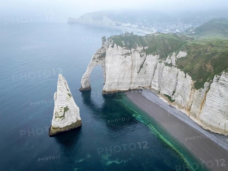 Aerial view of La Porte d'Aval and l'Aiguille on the Alabaster Coast in light fog, Etretat, Normandy, France