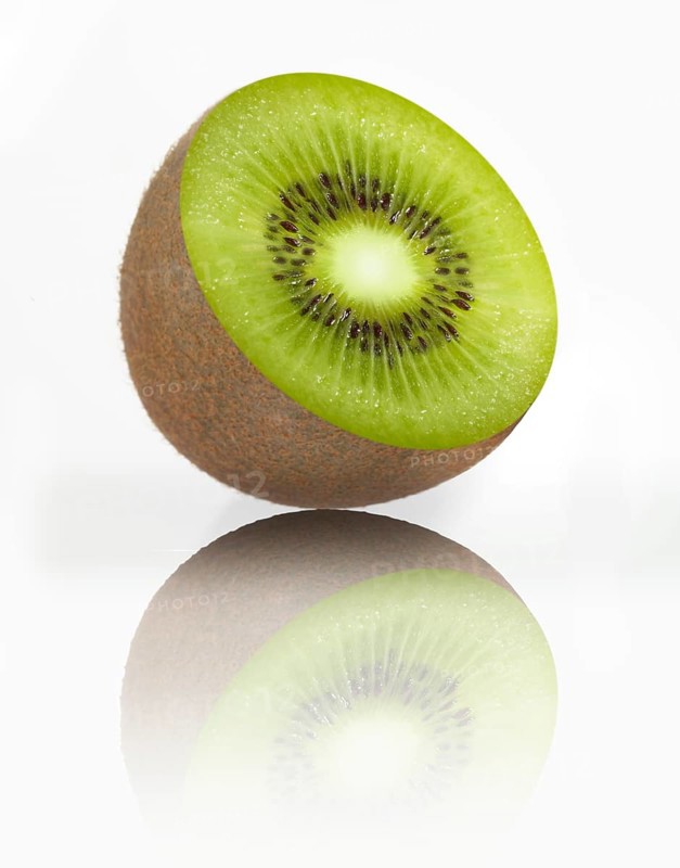 Half a kiwi, kiwi fruit, Chinese gooseberry (Actinidia deliciosa) against a white background, studio photograph