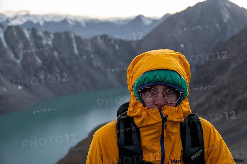 Mountaineer at Ala Köl mountain lake, in the Tien Shan Mountains, near Altyn Arashan, Kyrgyzstan