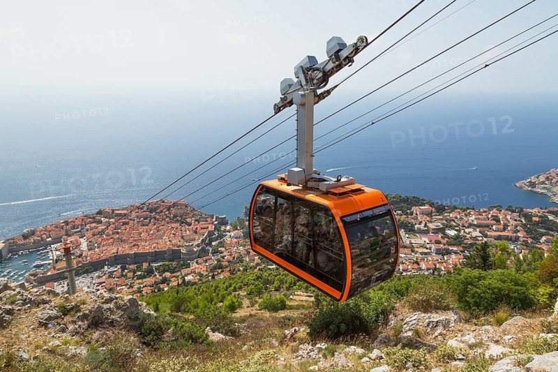 High angle view of cable car transporting tourists from Dubrovnik city center to top of Mount Srd in late summer, Croatia