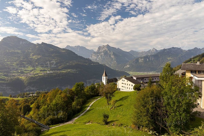 View of Amden with St Gallus church above Lake Walen, in the background Filzbach, Weesen and mountains, Amden, St. Gallen, Switzerland