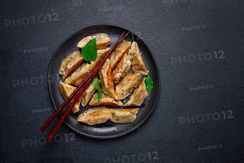 Japanese fried gyoza dumplings, with pork, sesame seeds, green onions