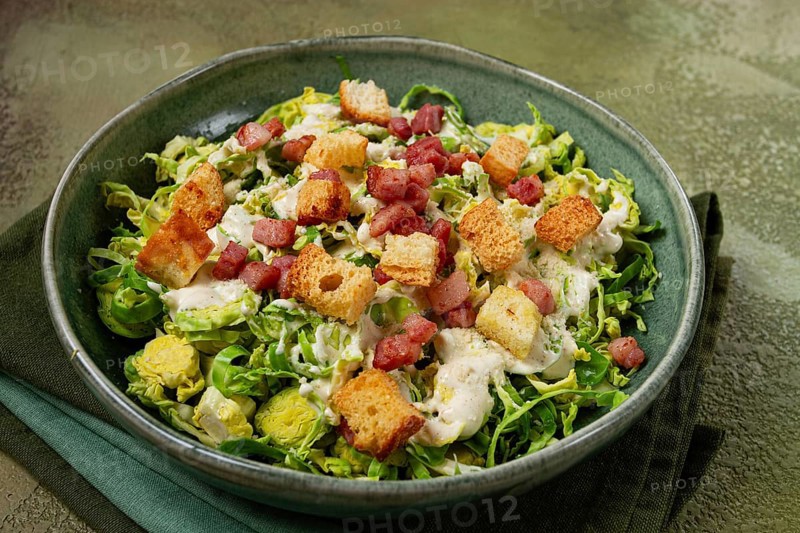 Brussels sprouts Caesar salad, with bacon and croutons, healthy food, homemade, no people