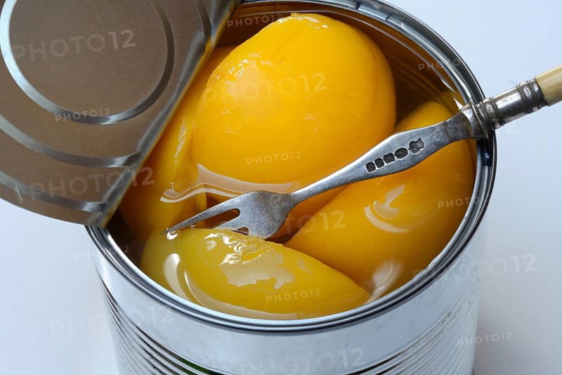 Peach, preserved peach halves with syrup in a tin can
