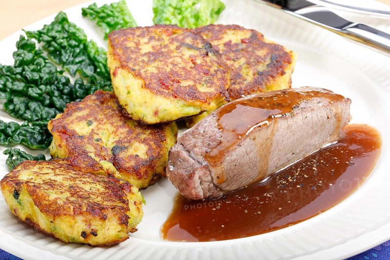 Swabian cuisine, medallions of wild boar with savoy cabbage cakes, meat dish, roasted, hearty, home cooking, typical Swabian, arranged on a plate, traditional cuisine reinterpreted, food photography, studio, Germany