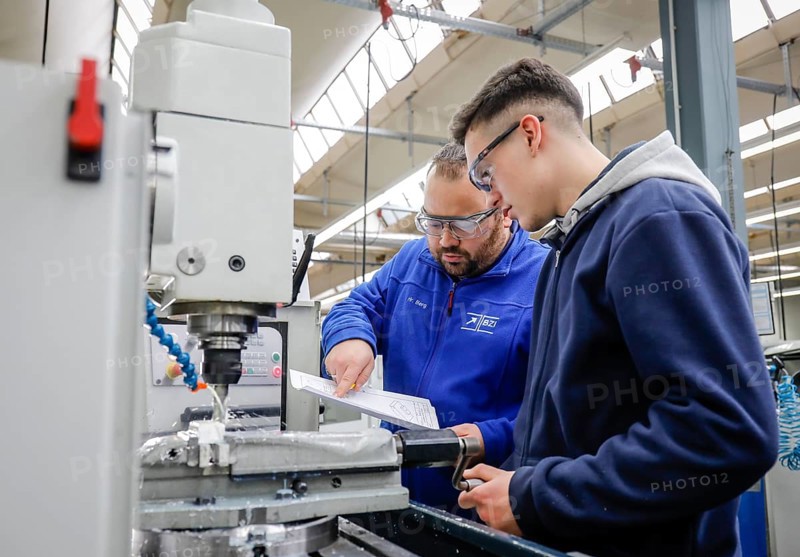 Remscheid, North Rhine-Westphalia, Germany - Trainees in metal professions, here with trainer at a machine tool, Vocational Training Centre of the Remscheid metal and electrical industry. - FOR EDITORIAL USE ONLY!
