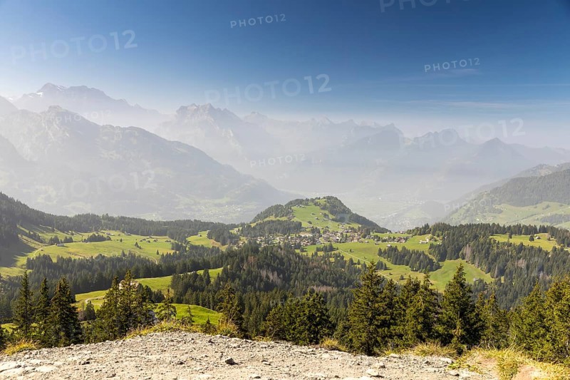 View from the summit of Flügenspitz to Arvenbüel with Chapf above Lake Walen, in the background Filzbach, Weesen and mountains in the fog, Amden, St. Gallen, Switzerland