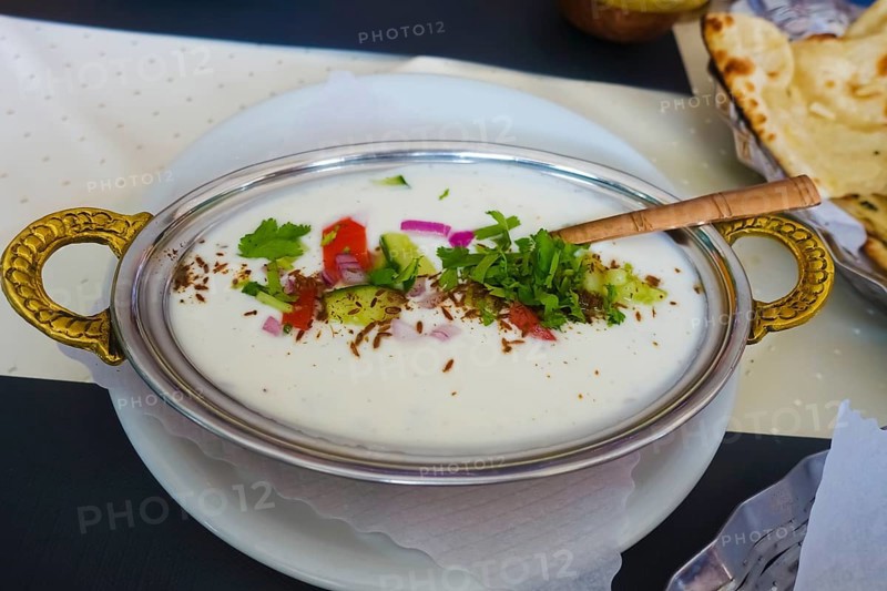Indian cuisine, Mix Raita, spiced yoghurt with onions, cucumber, tomatoes, herbs, savoury, salty, traditional cuisine, food photography, studio, Germany