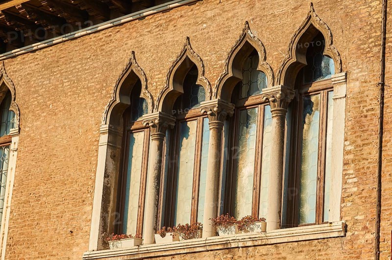 Windows of an old house on 'Campo santa margherita' town square in Venice on a sunny day in winter, Italy
