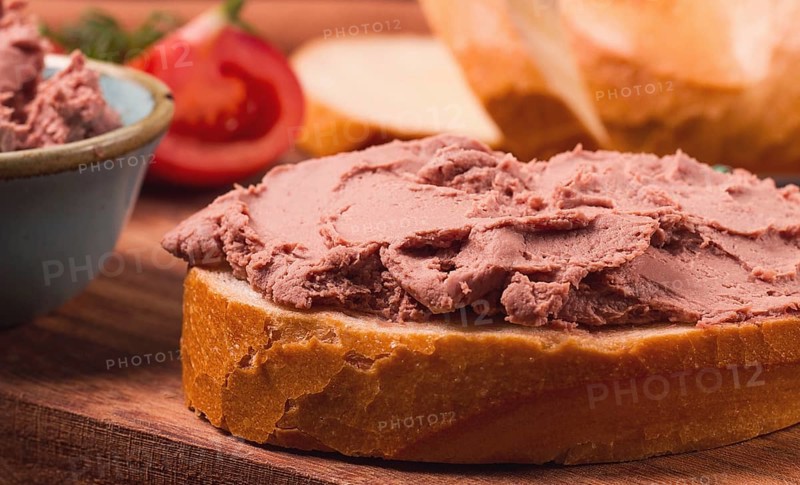 Liver meat pate spread, on white bread, on a wooden background, breakfast, close-up, no people, selective focus, pasticcio, pastete