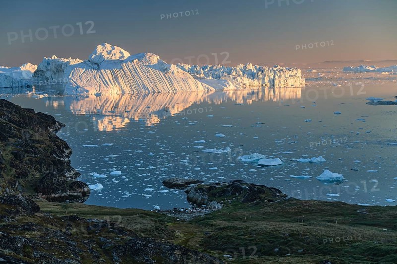 Icebergs and ice floes reflected in the water, summer, midnight sun, Jakobshavn glacier and ice fjord, Ilulissat Kangerlua, Disko Bay, West Greenland, Greenland