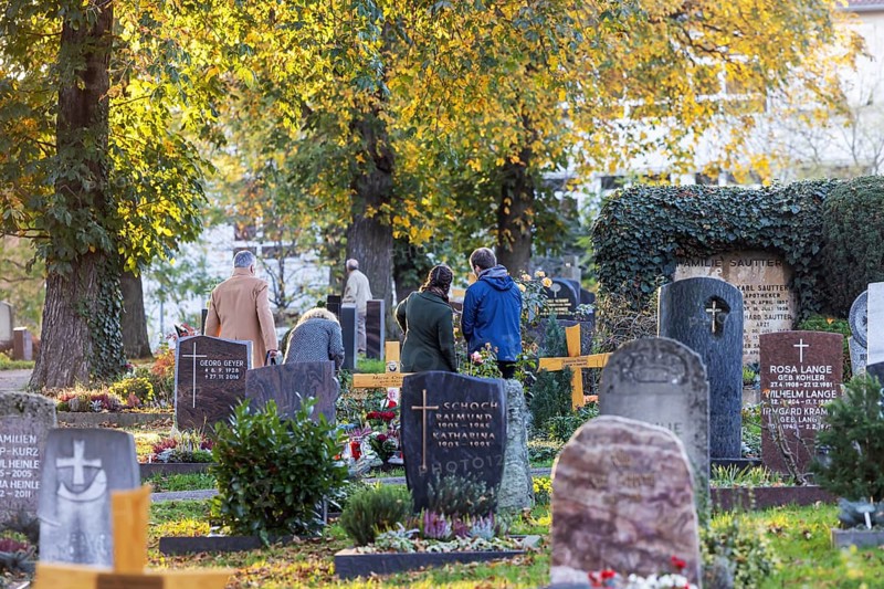 All Saints' Day at the Bergfriedhof cemetery in Stuttgart. Catholics commemorate their deceased relatives. Grave decorations and candles. Stuttgart, Baden-Württemberg, Germany