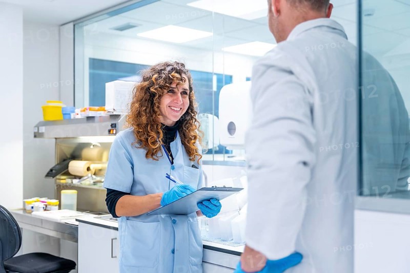 Scientists writing data working in a research laboratory in an hospital