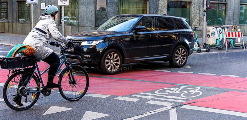 Red marked cycle path in the city centre, Berlin, Germany