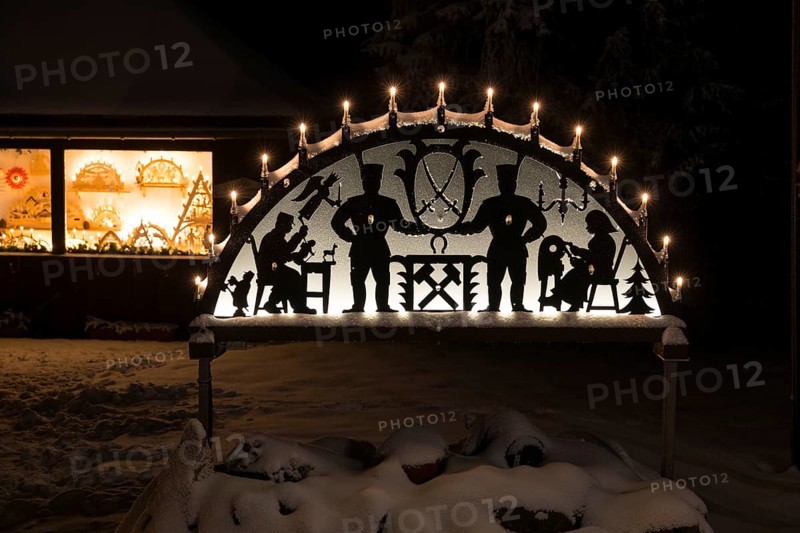 Snow-covered, illuminated arch of lights in Oberbärenburg, Altenberg, Saxony, Germany