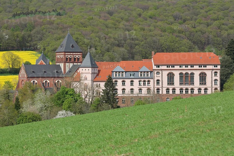 View of mission house church built in 1905, landscape, forest, rape field, mission house, Arnold-Janssen-Gymnasium, Sankt Wendel, Saarland, Germany
