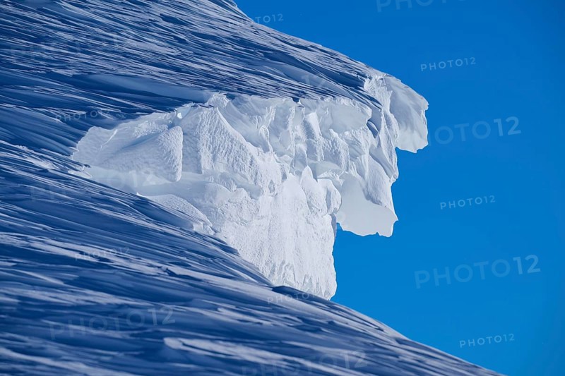 Close-up of a snow cornice under a clear blue sky, Gemmi Pass, Plattenhörner, Leukerbad, Leuk, Valais, Switzerland