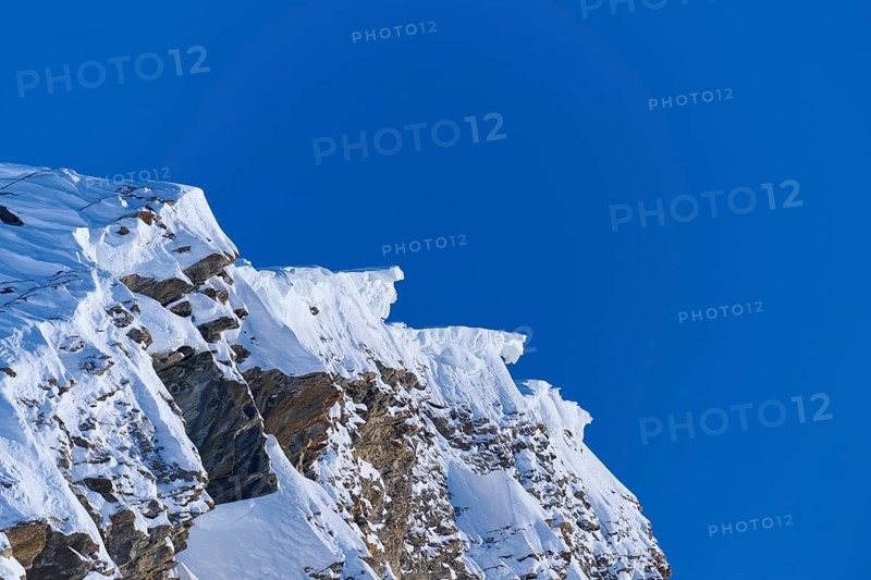 Snow-covered mountain peak with snow cornices under a clear blue sky, Gemmi Pass, Plattenhörner, Leukerbad, Leuk, Valais, Switzerland