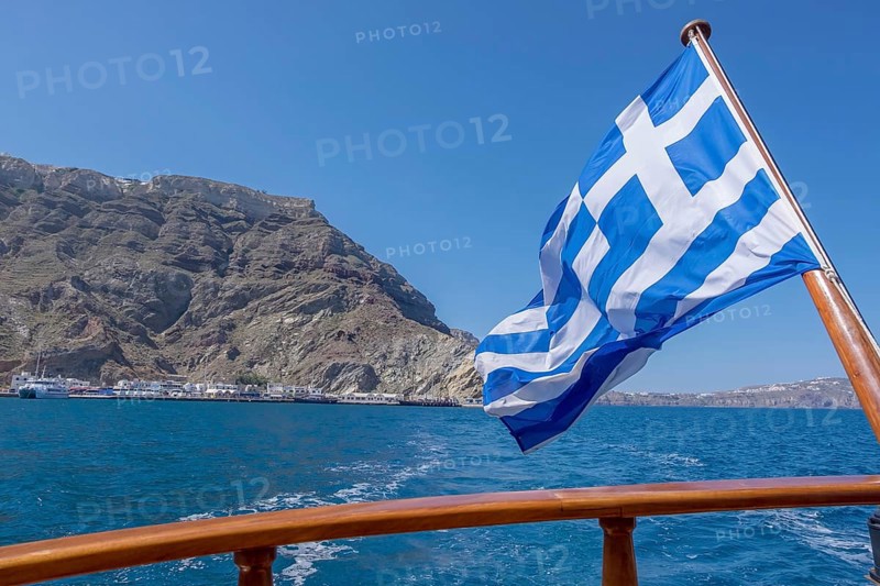 Greek flag waving in the wind on a boat, Greece