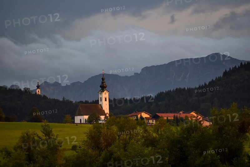View from the Ainringer moss nature reserve to Ulrichshögl with the Lattengebirge in the background at sunset, Bavaria, Germany
