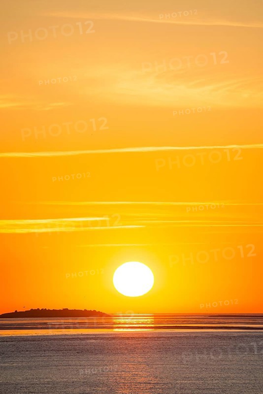 Picturesque, golden, magnificently beautiful sunset over the sea, Langlütjen II island far away, sun ball just above the horizon, orange glowing cloudless sky, wide sea in soft colours, calm atmosphere, radiant light mood, mouth of the Weser into the North Sea, Outer Weser, Bremerhaven, Land Bremen, Germany