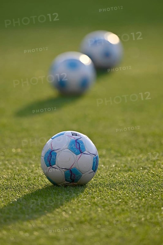 Adidas Derbystar match balls lying on grass, backlight, Voith-Arena, Heidenheim, Baden-Württemberg, Germany