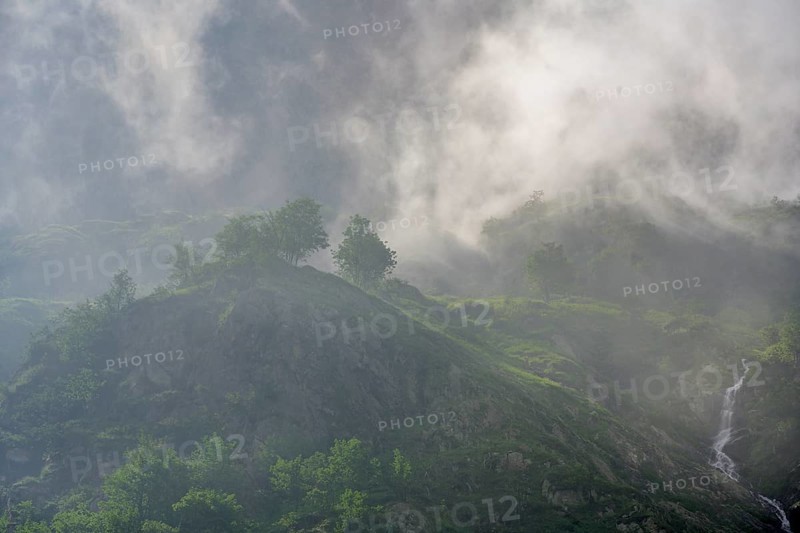 Clouds move over the mountains after a rain shower at Lago della Rovina, Entracque, province of Cuneo, Italy