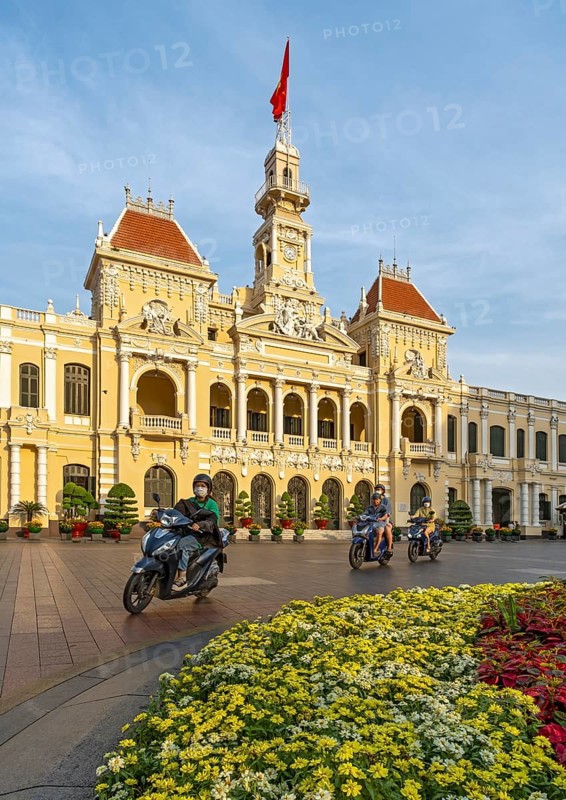 People on motorcycles in front of the Ho Chi Minh City Hall, Saigon, Vietnam