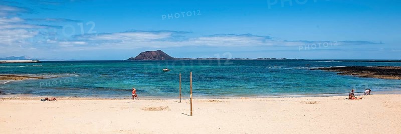 Panoramic photo of Corralejo beach in the background uninhabited island Islote de Lobos in the East Atlantic with cone of former volcano Montaña La Caldera, Corralejo, Fuerteventura, Canary Islands, Canary Islands