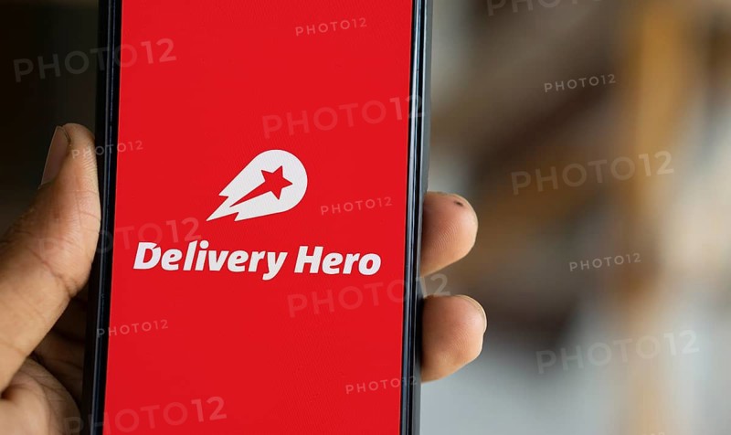 Delivery Hero logo is displayed on smartphone