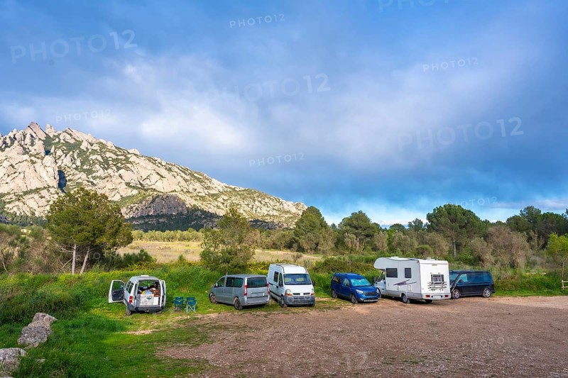 Camper vans enjoying the breathtaking view of the montserrat massif in catalonia, a popular destination for nature lovers and hikers