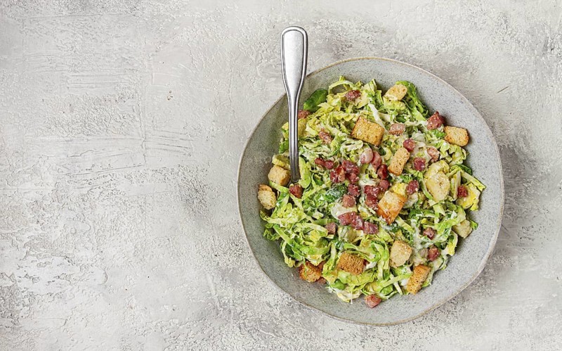 Brussels sprouts Caesar salad, with bacon and croutons, healthy food, homemade, no people