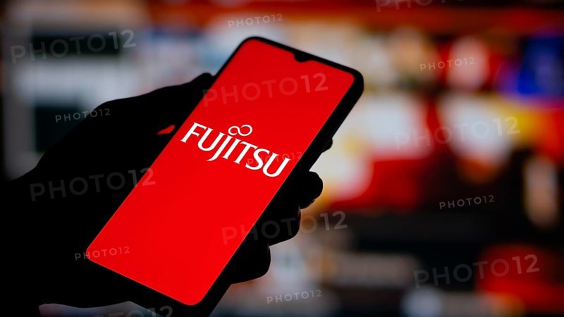 Fujitsu logo is displayed on smartphone. Fujitsu limited is a Japanese multinational tech company.