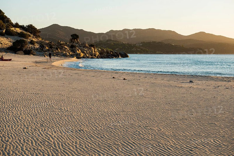 Lonely beach and rocks, sunrise, Spiaggia di Porto Giunco, Villasimius, south coast, Sardinia, Italy