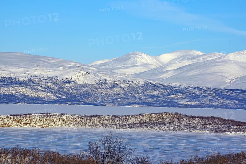 Snow-covered mountains and a frozen lake in a cold winter landscape, Abisko, Abisko National Park, Torneträsk, Lapland, Sweden