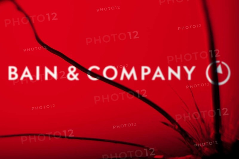 Bain & Company logo is visible on the broken glass. Bain & Company is an American management consulting company