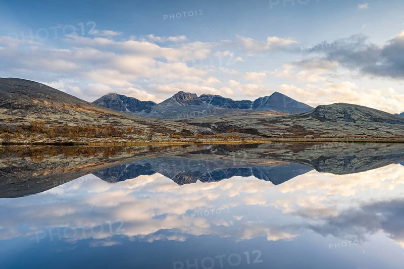Reflection of the autumn landscape in Rondane National Park, mountains Høgronden, Midtronden and Digerronden Dørålen, Dørålseter, Norway