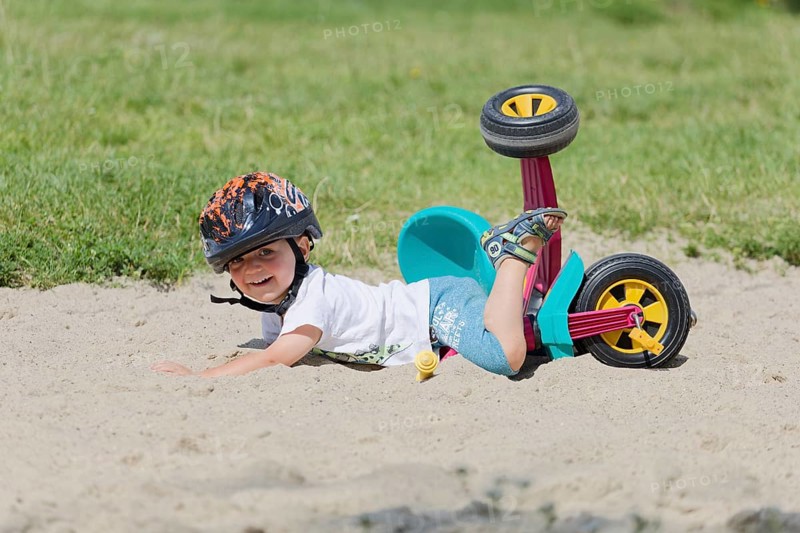 A boy in a helmet fell on his bicycle. Pobierowo, Poland